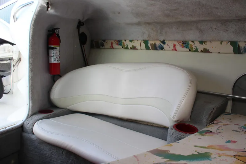 Slide: The Image of Interior of a 1996 Baja 232 boat with white seating and a fire extinguisher. - 30
