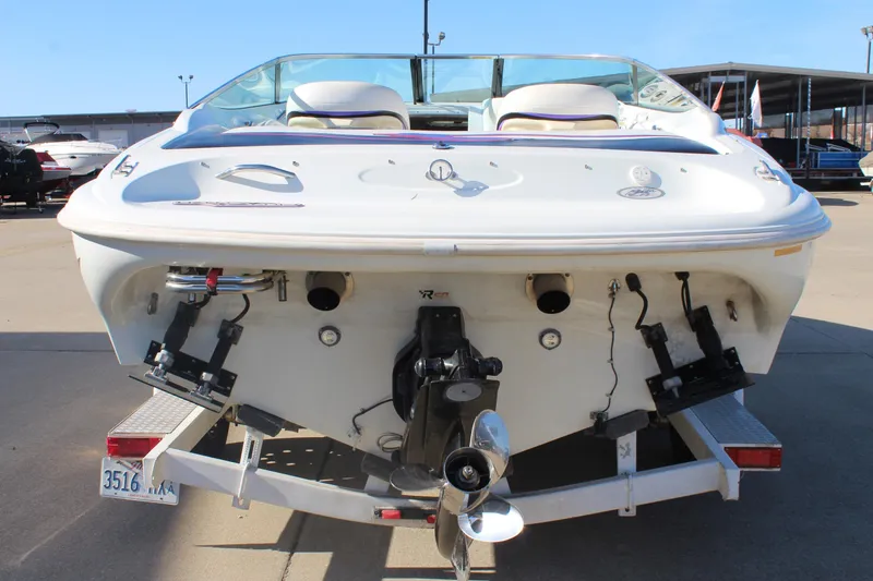 Slide: The Image of 1996 Baja 232 boat rear view on trailer, showcasing engine and propeller. - 7