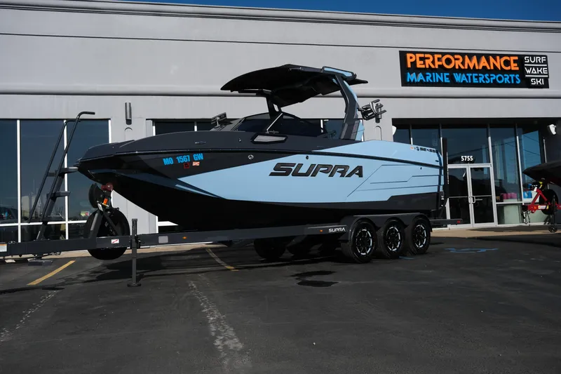 The Image of 2025 Supra SE550 boat on trailer at Performance Marine Watersports dealership. - 0