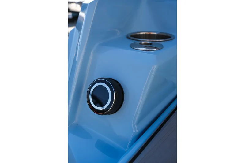 Slide: The Image of Close-up of 2025 Supra SE550 boat's sleek blue exterior with chrome details. - 13