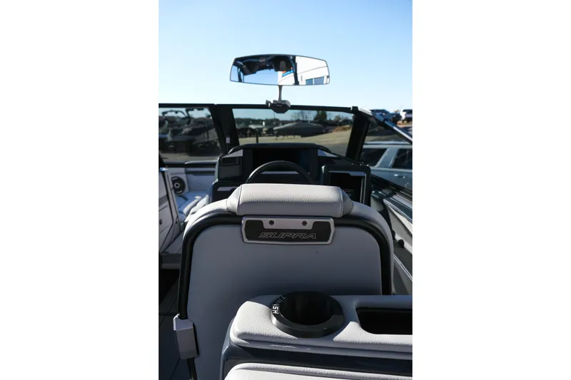Slide: The Image of 2025 Supra SE550 boat interior with steering wheel and seating. - 20