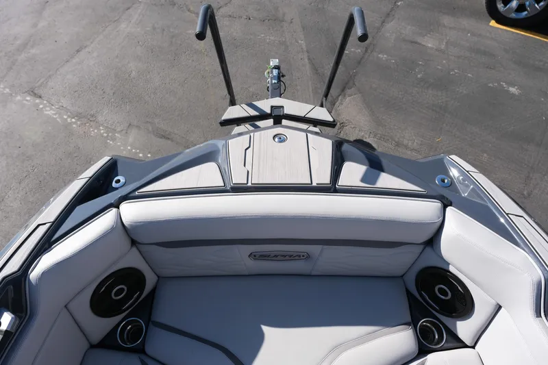 Slide: The Image of 2025 Supra SE550 boat interior with cushioned seating and built-in speakers. - 29