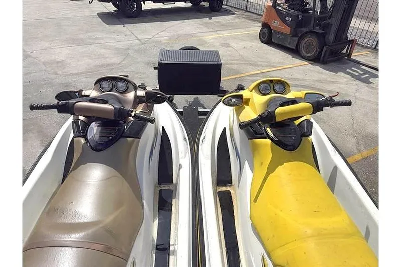 Slide: The Image of Two 2005 Sea Doo GTI LE-RFI jet skis parked on a trailer. - 6