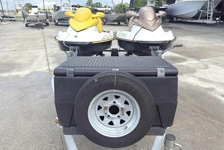 Slide: The Image of Two 2005 Sea Doo GTI LE-RFI jet skis on a trailer in a marina. - 7