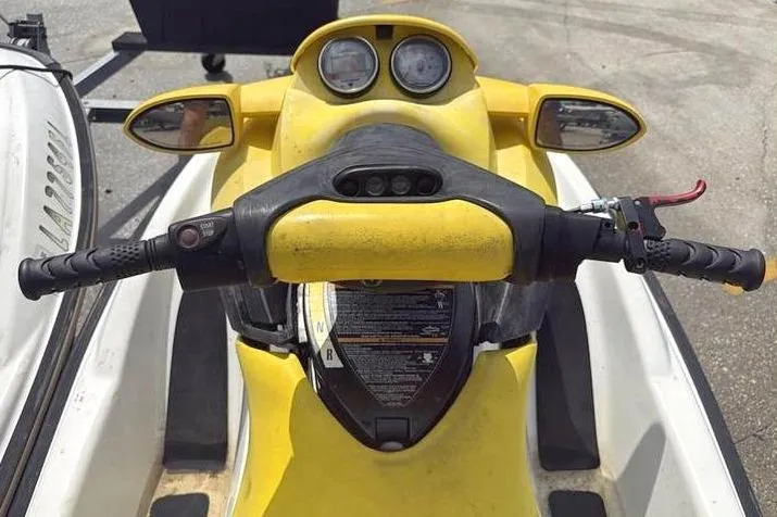 Slide: The Image of 2005 Sea Doo GTI LE-RFI yellow jet ski handlebars and dashboard view. - 9