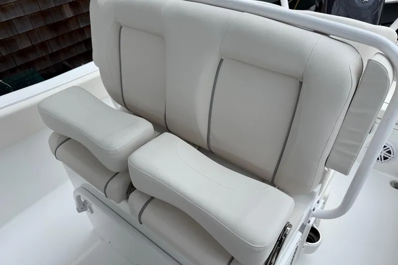 Slide: The Image of 2026 Sea Hunt Ultra 235 SE boat seat with cushioned armrests and backrest. - 10