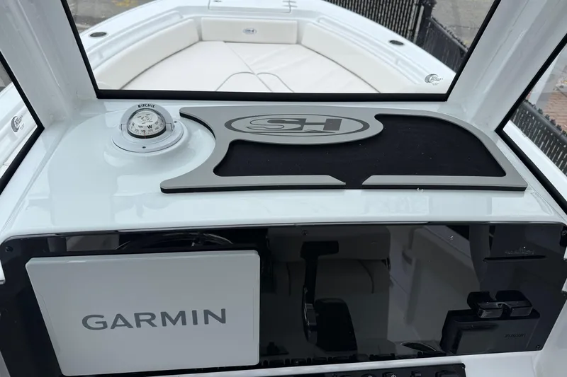 Slide: The Image of 2026 Sea Hunt Ultra 235 SE dashboard with Garmin navigation and Ritchie compass. - 12