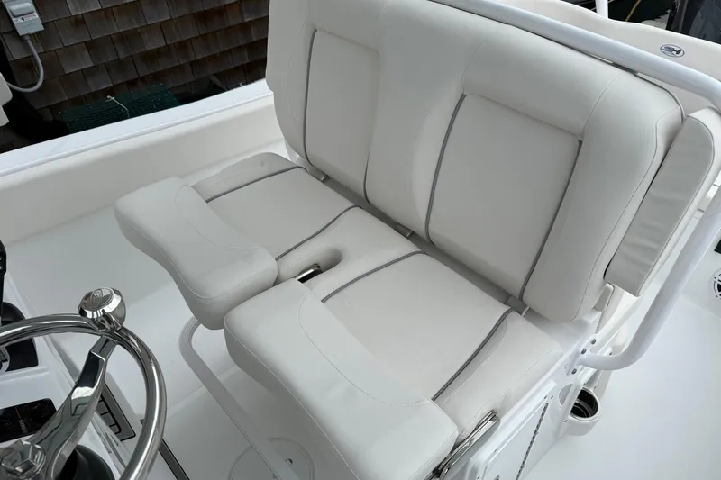 Slide: The Image of 2026 Sea Hunt Ultra 235 SE boat interior with plush white seating. - 13