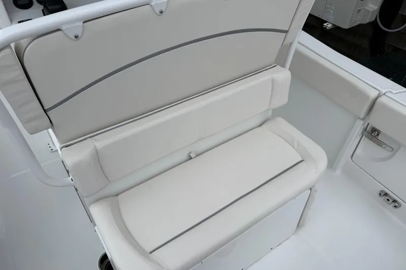 Slide: The Image of 2026 Sea Hunt Ultra 235 SE boat seating, featuring white cushioned bench. - 14