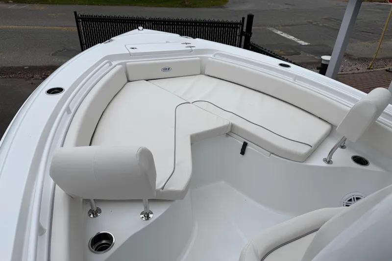 Slide: The Image of 2026 Sea Hunt Ultra 235 SE boat with white cushioned seating area. - 18