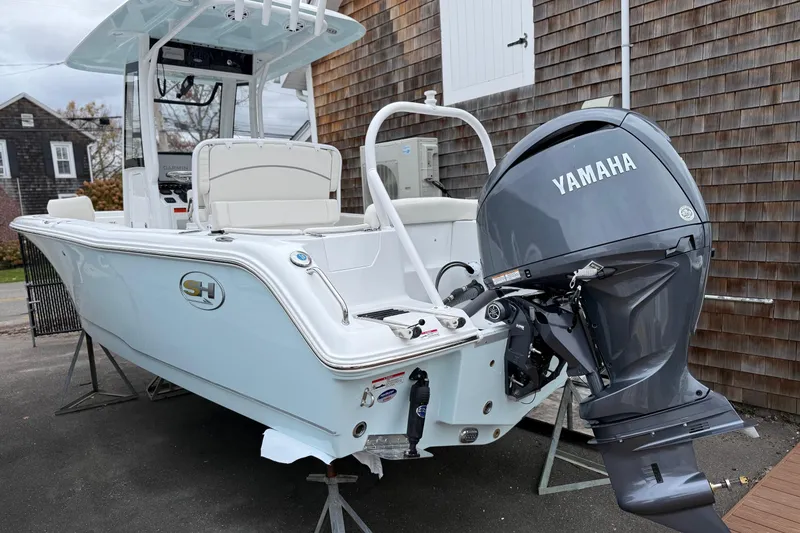 Slide: The Image of 2026 Sea Hunt Ultra 235 SE boat with Yamaha outboard motor, parked on a stand. - 2