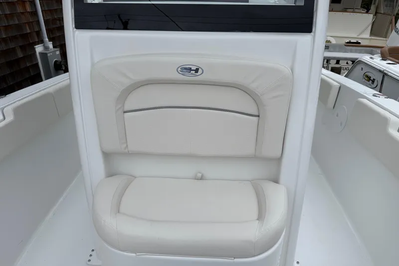Slide: The Image of 2026 Sea Hunt Ultra 235 SE boat seat with white cushioned upholstery. - 7