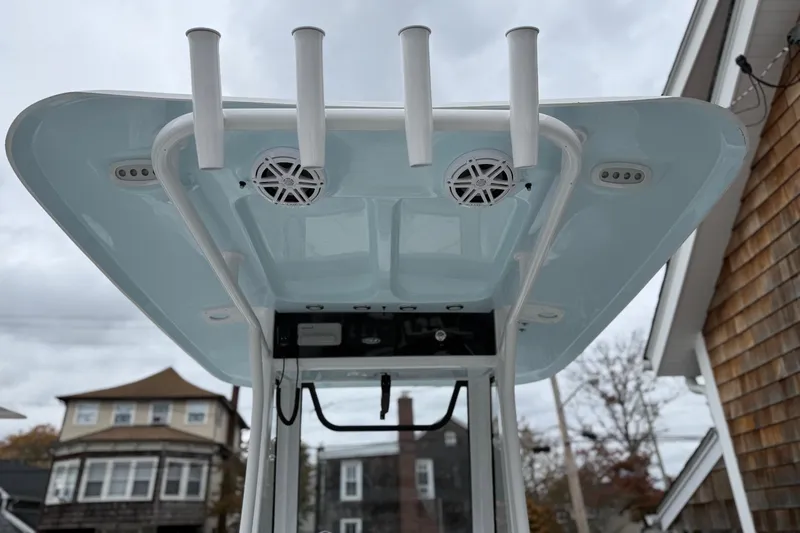 Slide: The Image of 2026 Sea Hunt Ultra 235 SE boat with rod holders and speakers on the T-top. - 9