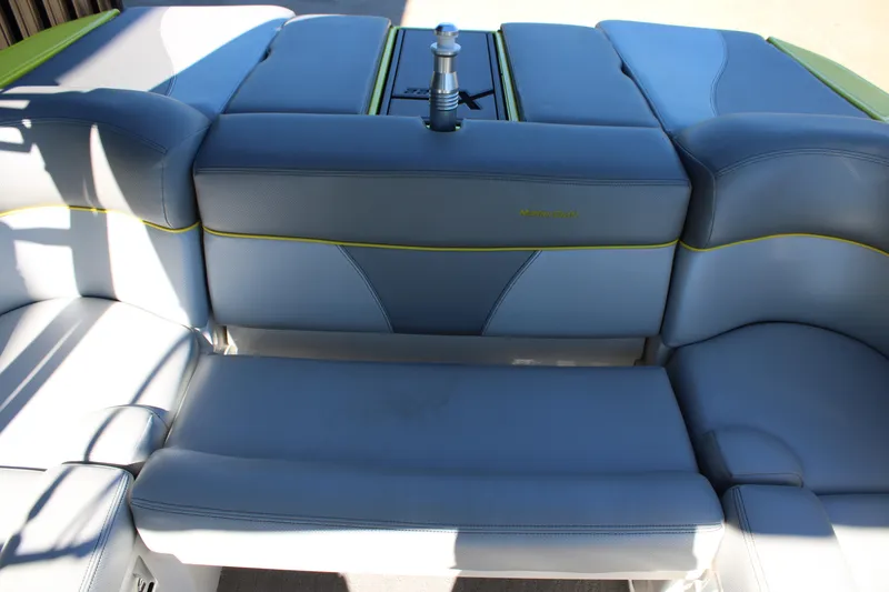 Slide: The Image of 2018 MasterCraft XT22 boat interior with blue and gray seating. - 10