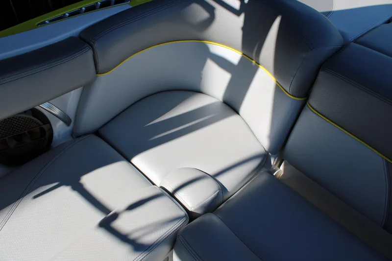 Slide: The Image of 2018 MasterCraft XT22 boat interior with gray seating and yellow accents. - 11