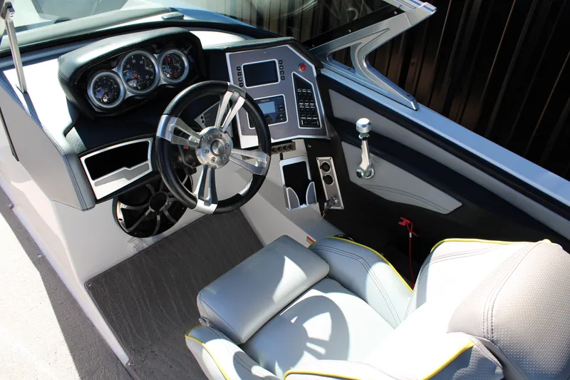 Slide: The Image of 2018 MasterCraft XT22 boat cockpit with modern steering and control panel. - 17