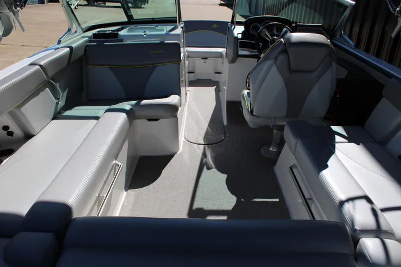 Slide: The Image of Interior of a 2018 MasterCraft XT22 boat with seating and steering area. - 18