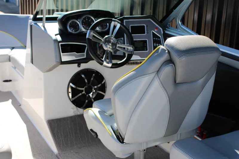 Slide: The Image of 2018 MasterCraft XT22 boat interior with steering wheel and dashboard controls. - 22