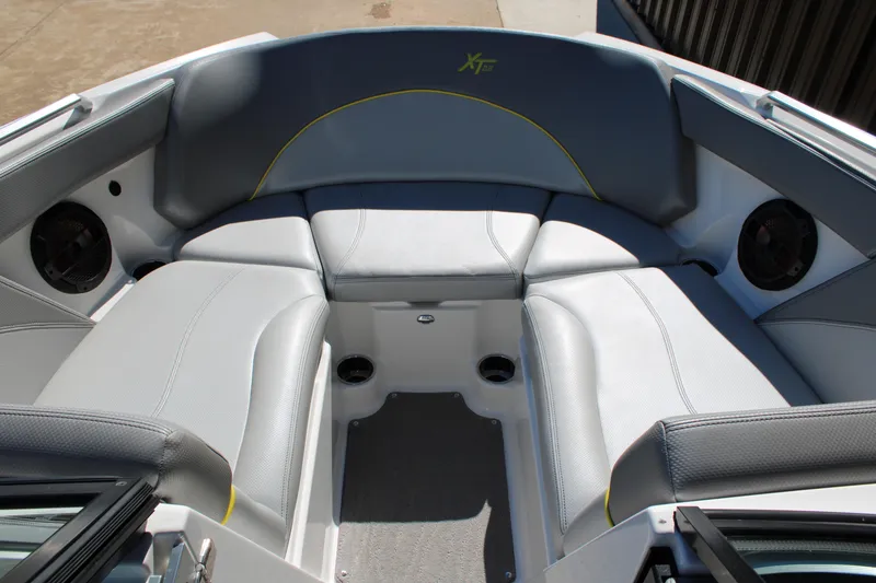 Slide: The Image of 2018 MasterCraft XT22 boat interior with gray seating and speakers. - 7