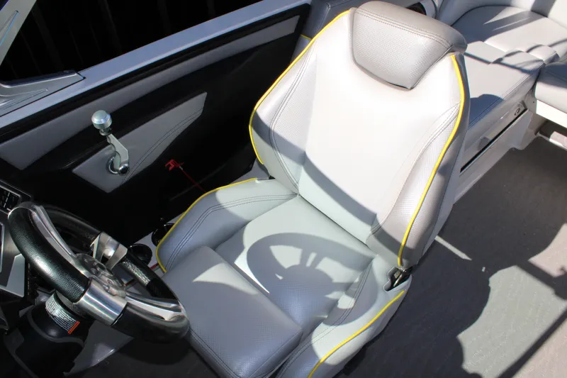 Slide: The Image of 2018 MasterCraft XT22 boat interior with steering wheel and captain's seat. - 8