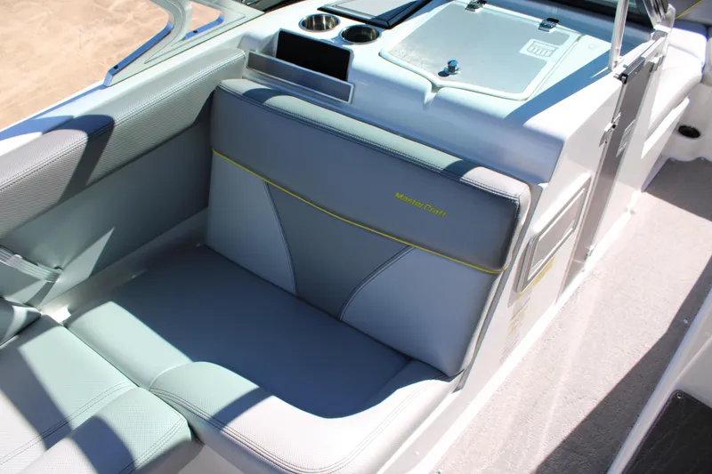 Slide: The Image of 2018 MasterCraft XT22 boat interior with gray seating and cup holders. - 9