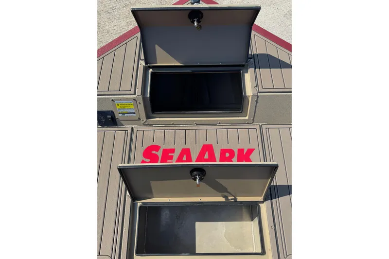 Slide: The Image of 2026 SeaArk Easy 200 boat deck with open storage compartments and logo. - 13