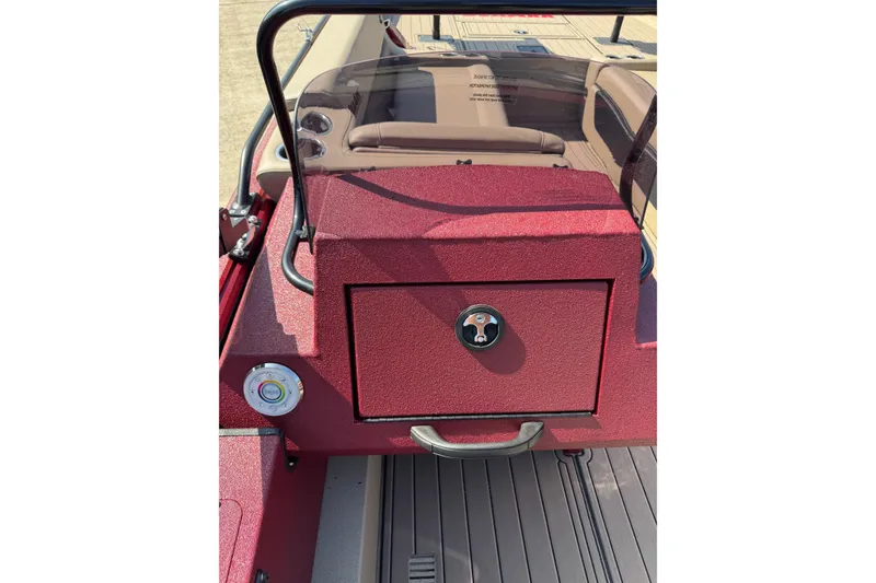 Slide: The Image of 2026 SeaArk Easy 200 boat dashboard with red finish and storage compartment. - 17