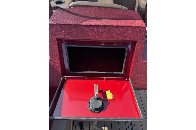 Slide: The Image of 2026 SeaArk Easy 200 boat dashboard with open compartment and cup holders. - 18