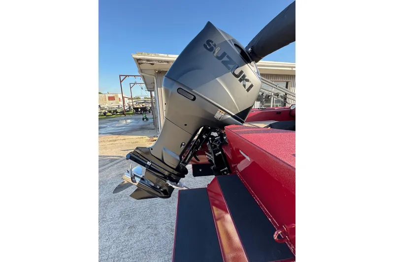 Slide: The Image of 2026 SeaArk Easy 200 with Suzuki outboard motor, red hull, parked outdoors. - 4