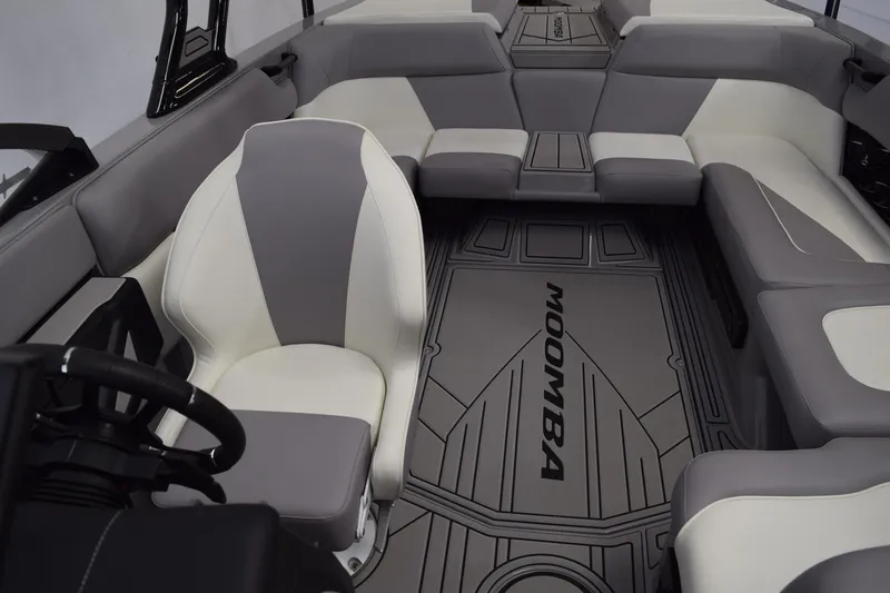 Slide: The Image of 2026 Moomba Craz boat interior with gray and white seating, branded flooring. - 10