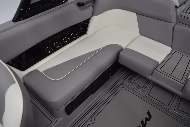 Slide: The Image of 2026 Moomba Craz boat interior with gray and white seating, cup holders, and sleek design. - 11