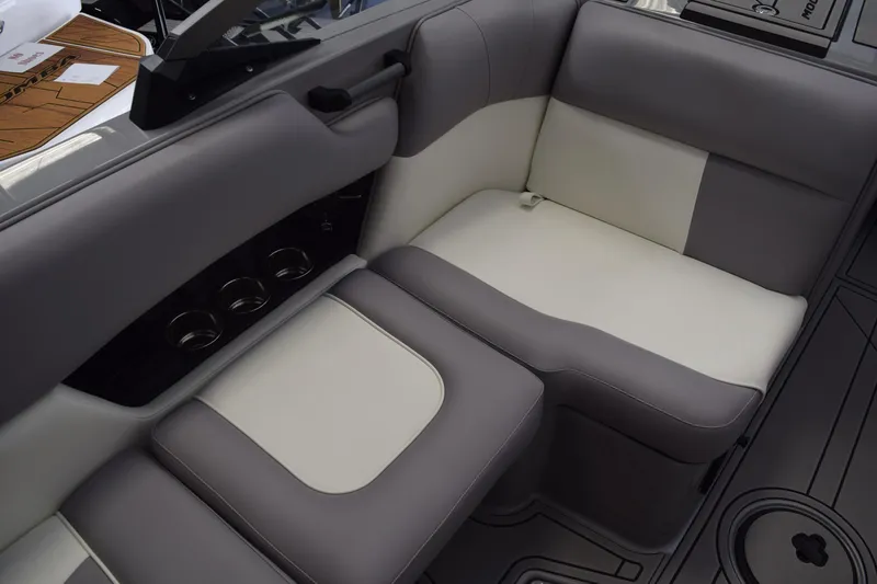 Slide: The Image of 2026 Moomba Craz boat interior with gray and white seating and cup holders. - 8
