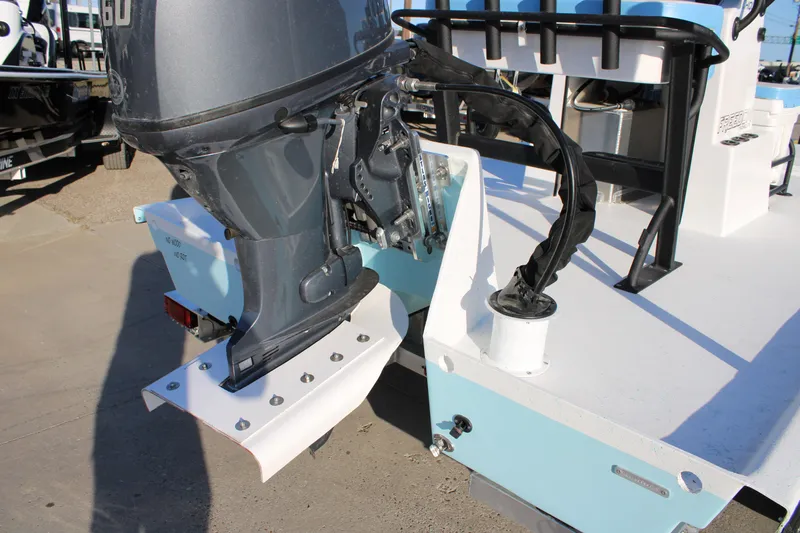 Slide: The Image of 2026 Freedom Boats Chiquita with outboard motor, showcasing rear deck and engine details. - 14