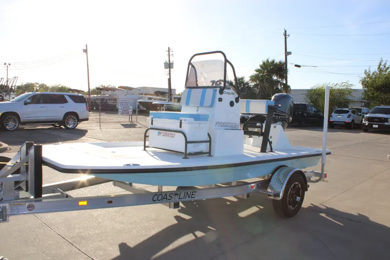 Slide: The Image of 2026 Freedom Boats Chiquita on trailer in sunny outdoor setting. - 19