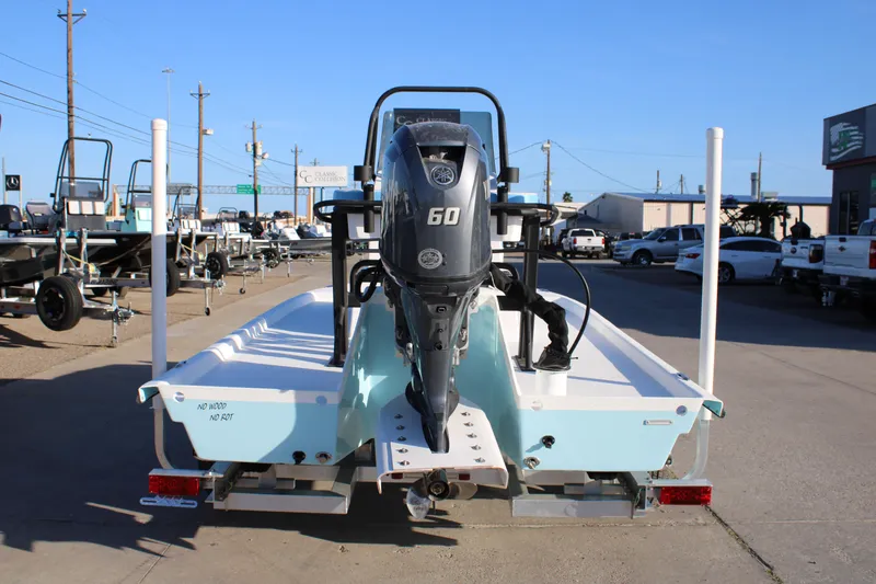 Slide: The Image of 2026 Freedom Boats Chiquita with 60 HP motor, displayed in a dealership lot. - 3