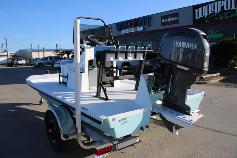 Slide: The Image of 2026 Freedom Boats Chiquita with Yamaha engine, parked at a dealership. - 4