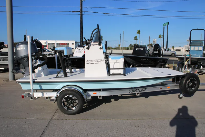 The Image of 2026 Freedom Boats Chiquita on trailer, featuring Yamaha engine, displayed outdoors. - 1