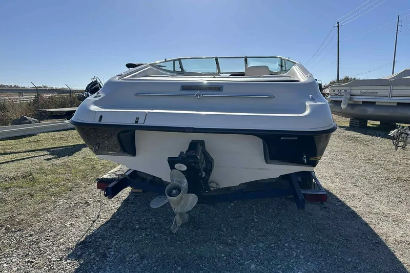 Slide: The Image of 1994 Crownline 225 BR boat on trailer, rear view, outdoors on gravel. - 10