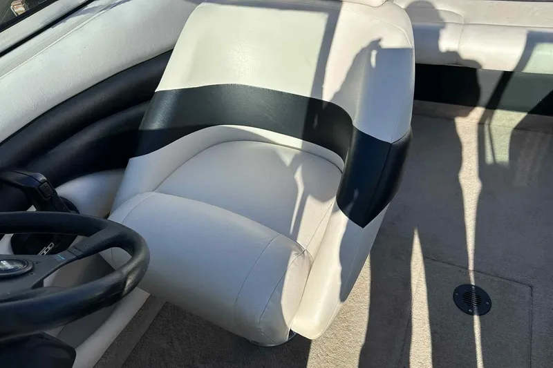 Slide: The Image of 1994 Crownline 225 BR boat interior with white and black seating. - 4