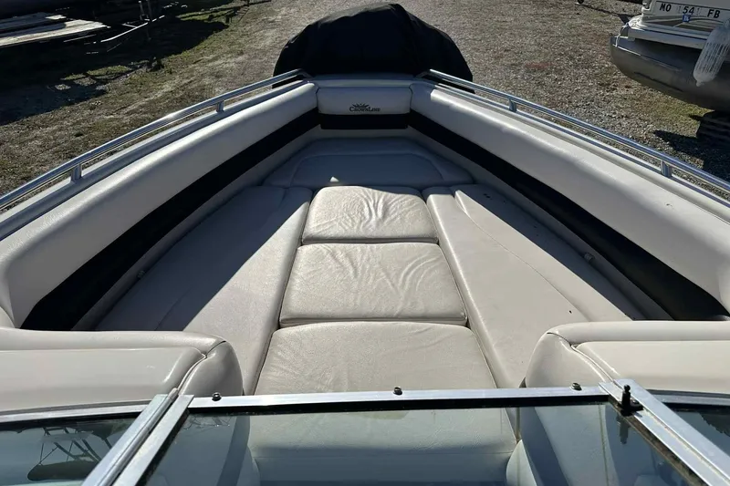 Slide: The Image of 1994 Crownline 225 BR boat interior with cushioned seating and metal railings. - 9