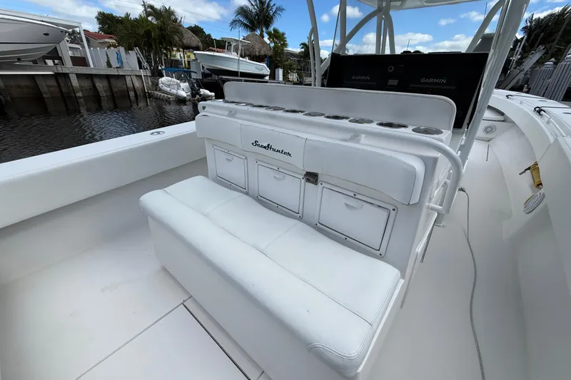 Slide: The Image of 2010 SeaHunter 40 boat interior with white seating and storage compartments. - 10