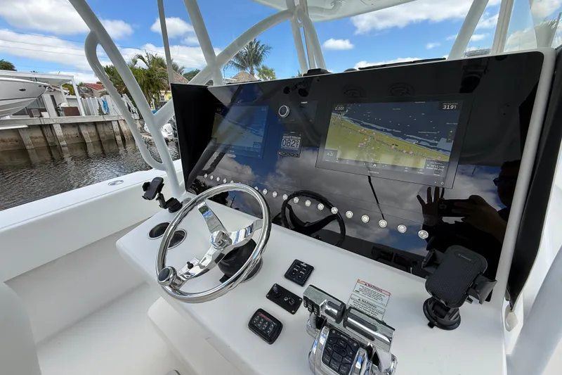 Slide: The Image of Steering console of 2010 SeaHunter 40 boat with navigation display and controls. - 12