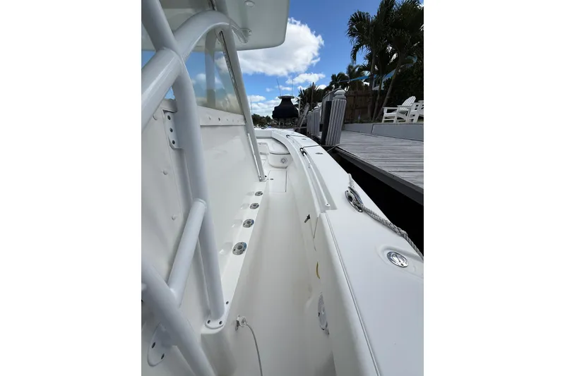 Slide: The Image of 2010 SeaHunter 40 boat docked, showcasing sleek white design and spacious deck. - 13