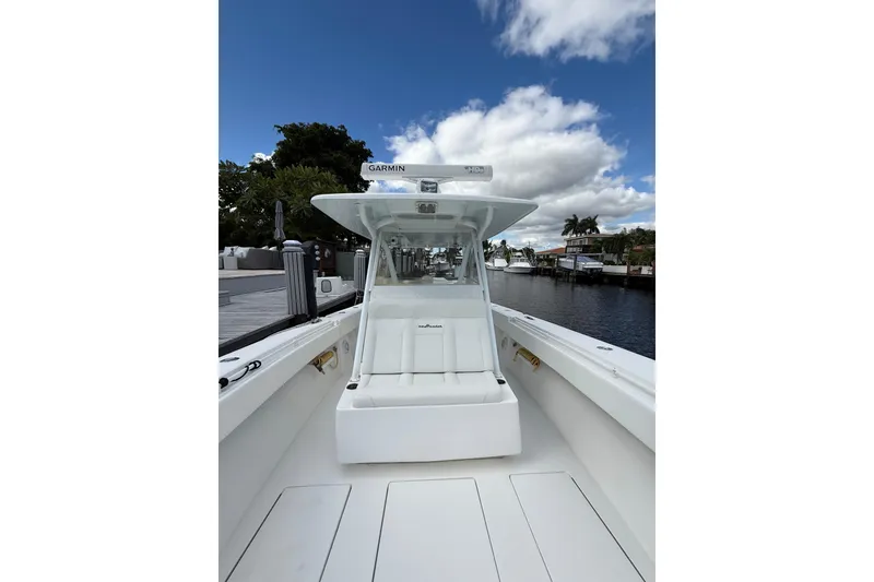 Slide: The Image of 2010 SeaHunter 40 boat with Garmin equipment, docked by a scenic waterfront. - 15