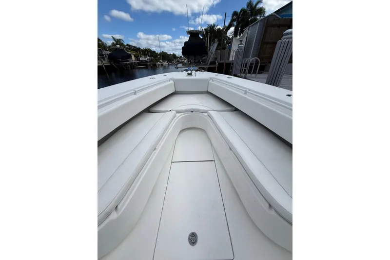 Slide: The Image of 2010 SeaHunter 40 boat interior with white seating and clear sky background. - 16