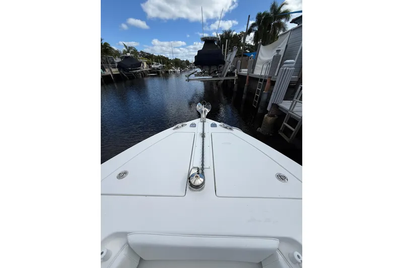 Slide: The Image of Bow view of 2010 SeaHunter 40 boat docked in a serene marina. - 17
