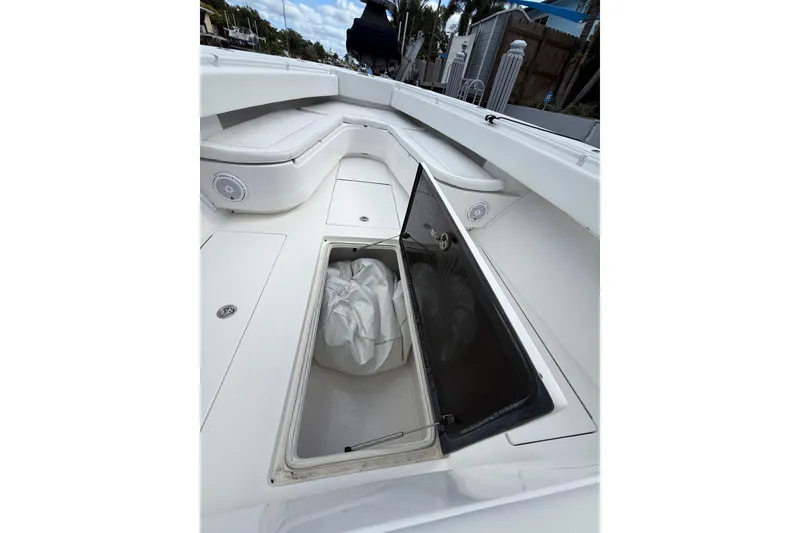 Slide: The Image of 2010 SeaHunter 40 boat interior with open storage compartment and cushioned seating. - 19
