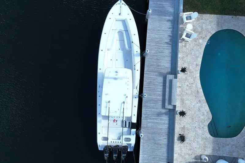 Slide: The Image of Aerial view of a 2010 SeaHunter 40 boat docked beside a pool and patio. - 2