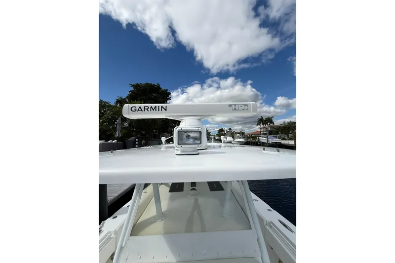 Slide: The Image of 2010 SeaHunter 40 boat with Garmin radar, docked under a partly cloudy sky. - 21