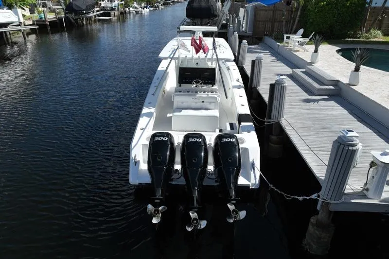 Slide: The Image of 2010 SeaHunter 40 boat docked, featuring triple 300 horsepower engines. - 3